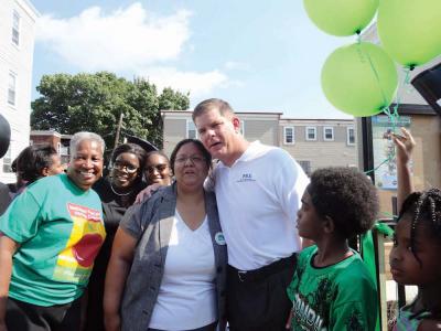 Woolson Street garden: Mayor Walsh posed for a photo with Vidya Tikku of BNAN and Vivien Morris, far right, of Mattapan Food &amp;amp;amp; Fitness Coalition. Shown at center is Mirlande Joseph, whose twin brother was murdered on the street in 2006. Joseph helped to push for the creation of the new community garden, shown below. Photos by India Smith